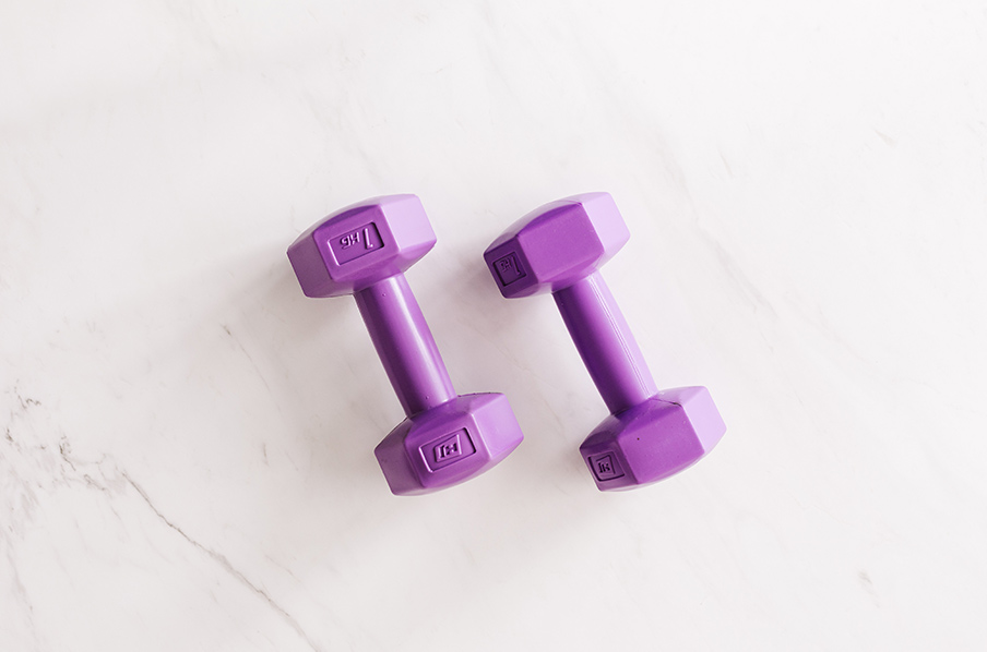 Canva - Purple all cast dumbbells on marble surface